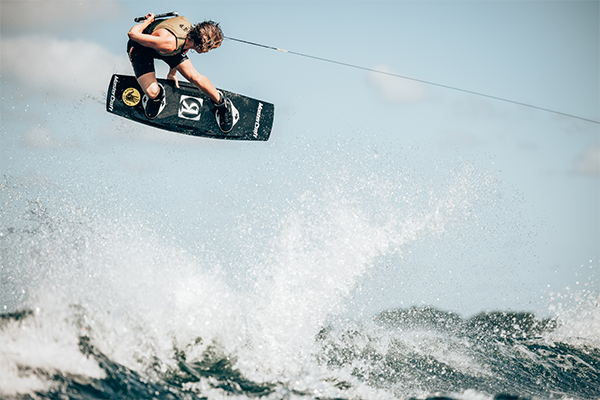 Wakeboarder gets air on lime green board