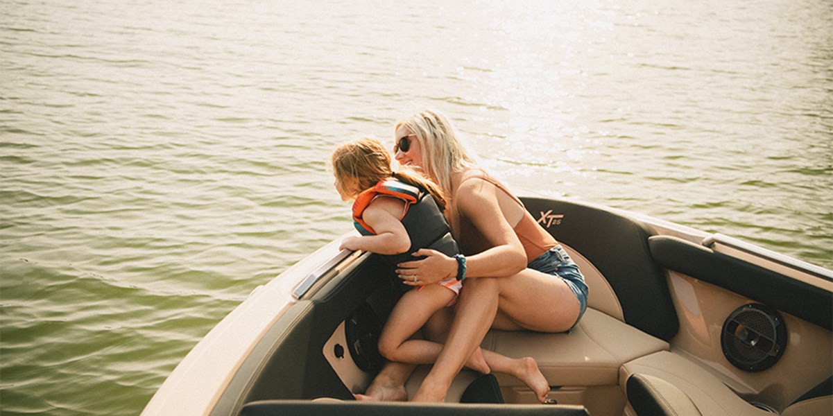 A woman and a little girl look over the bow of the XT25