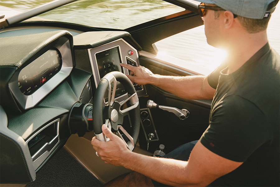 A man adjusts the wave settings on his XT25 wake boat