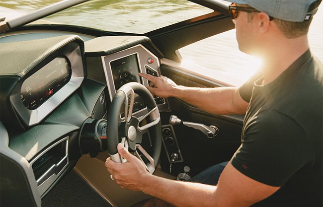 A man adjusts the wave settings on his XT25 wake boat