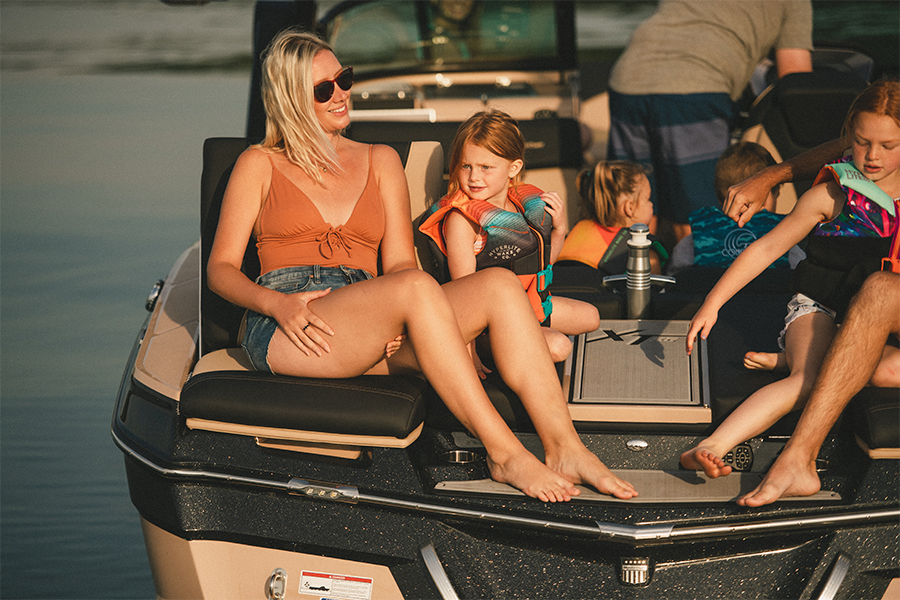 A woman laughs with a little girls in transom seats on the XT25