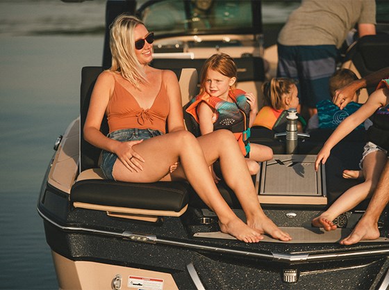 A woman laughs with a little girls in transom seats on the XT25