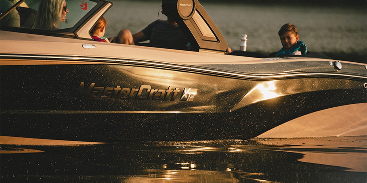 A tan and black XT25 reflects in water