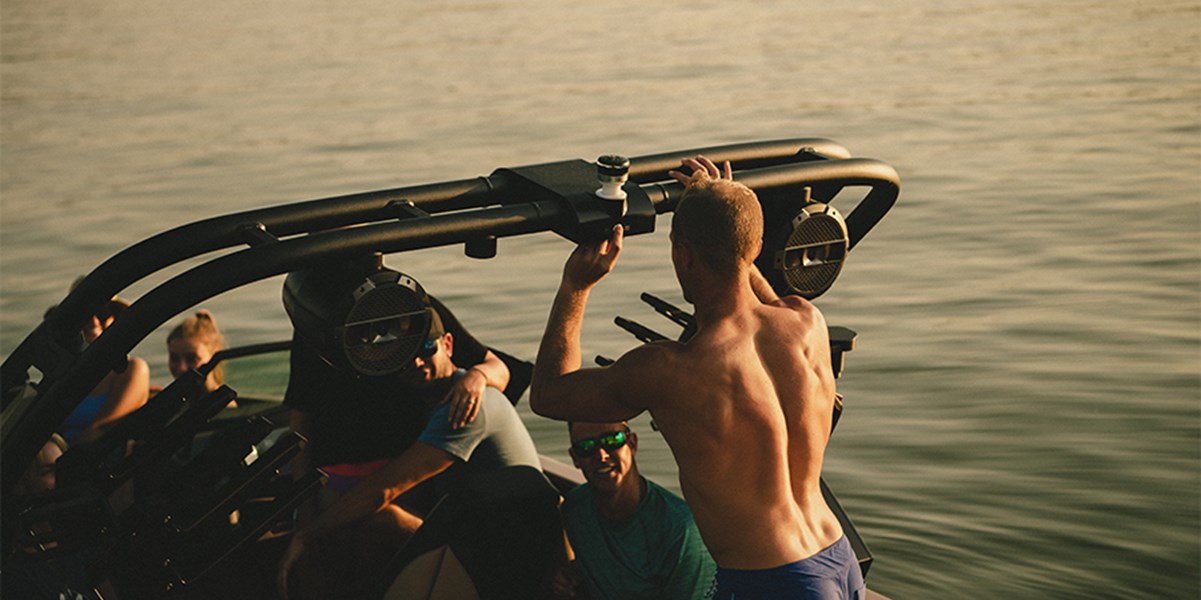 A man lowers the tower on his XT25 wake boat
