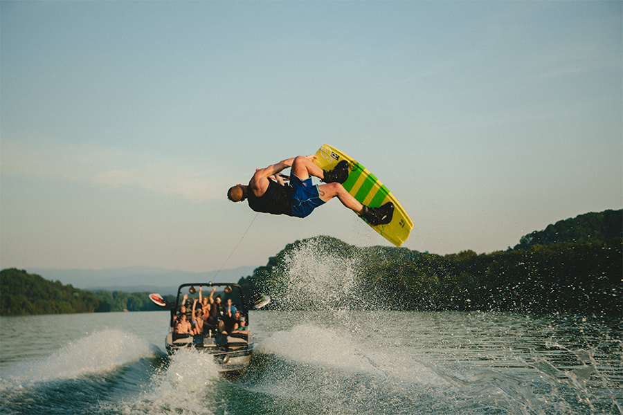 A wakeboarder gets air behind the XT25 wake boat