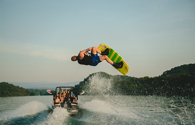 A wakeboarder gets air behind the XT25 wake boat